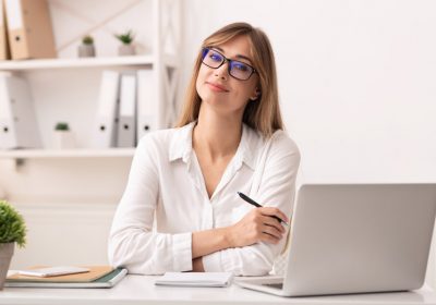 Entrepreneurship. Confident Businesswoman Smiling At Camera Sitting At Laptop In Modern Office.
